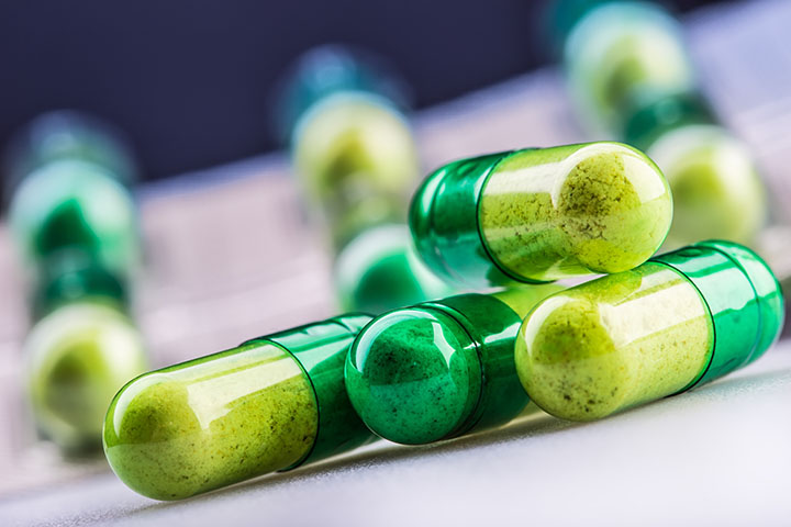 Pills. Tablets. Capsule. Heap of pills. Medical background. Close-up of pile of yellow green tablets - capsule